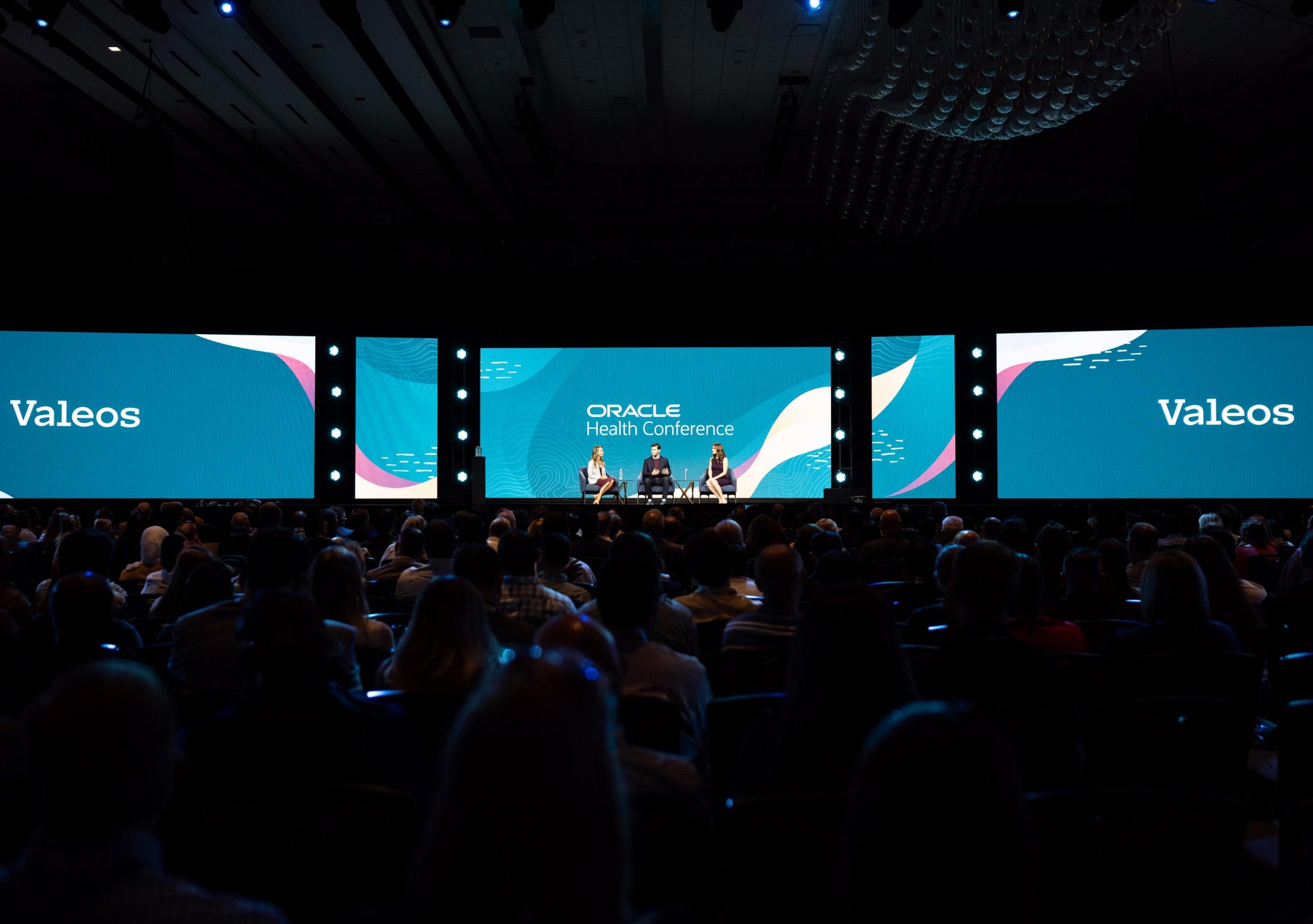 Tristan Mace, Jordan Mace, and Stephanie Trunzo on stage at Oracle Health Conference 2023